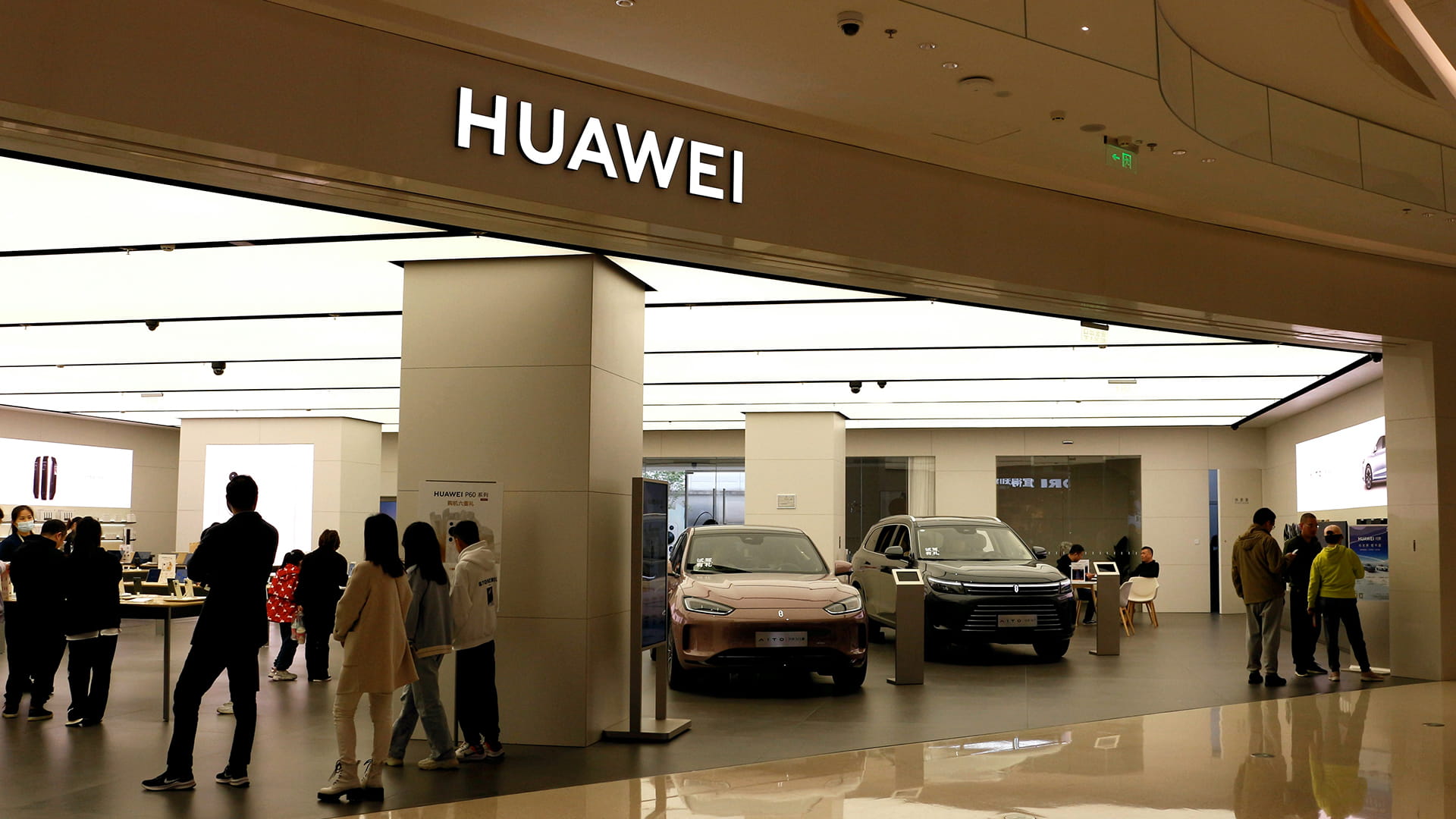 Photo shows a Huawei store displaying cars alongside smartphones and other devices.