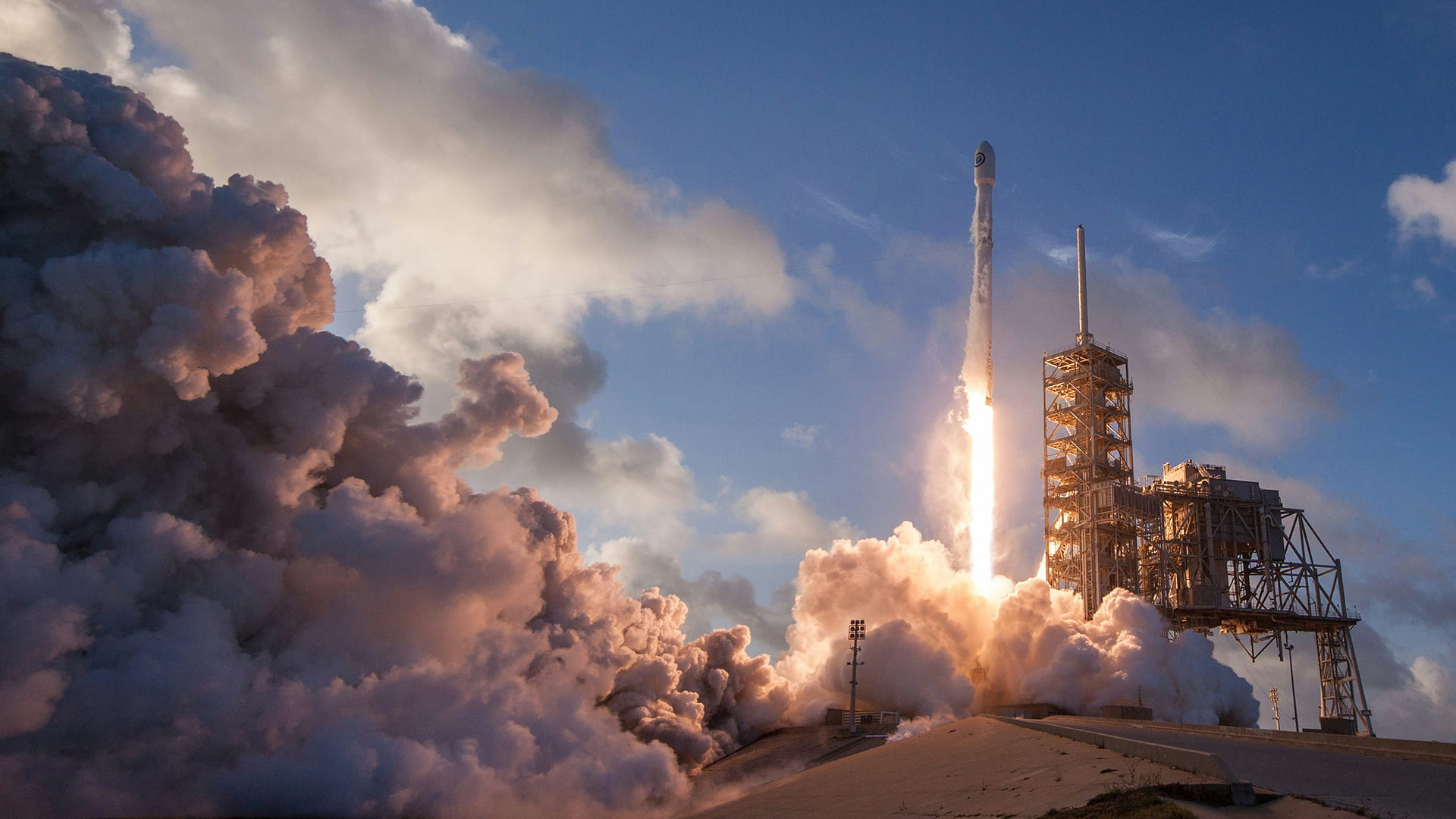 Photo shows a Falcon 9 launch vehicle developed by SpaceX lifting off.