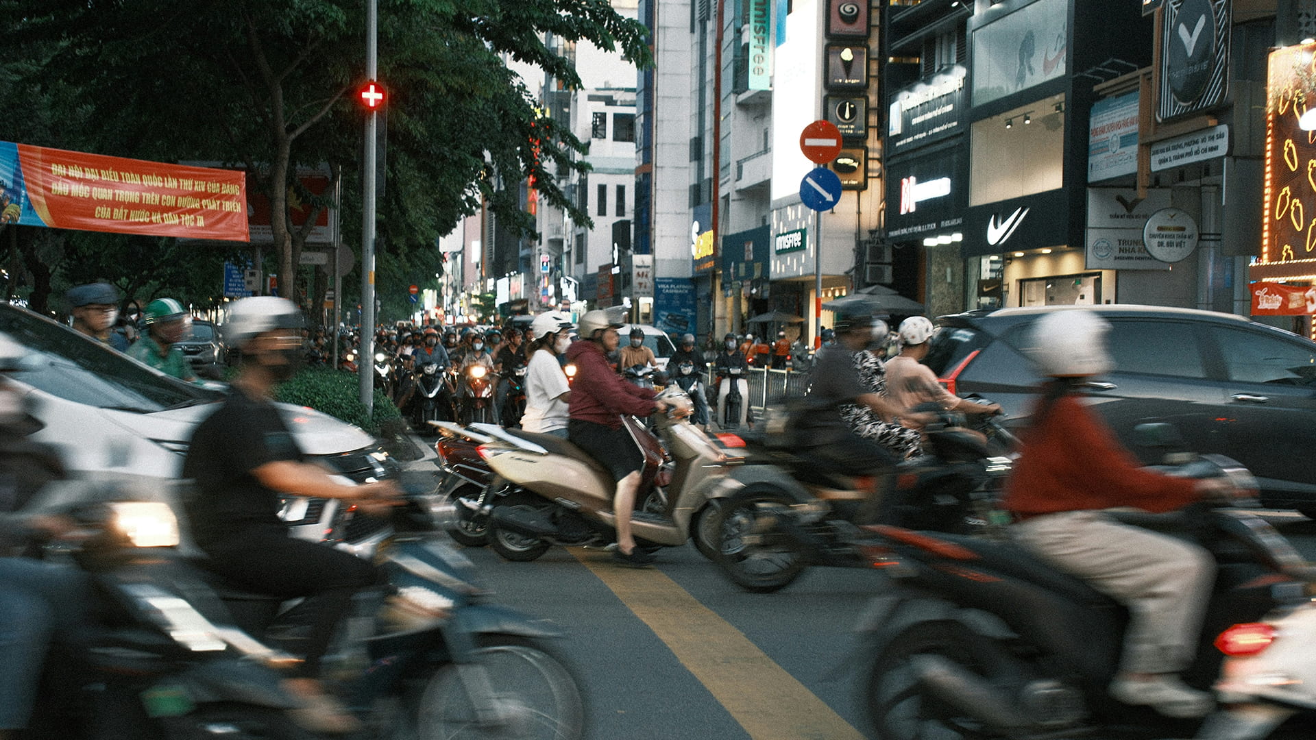 Photo shows motorbike riders on a busy road in Hanoi, Vietnam.