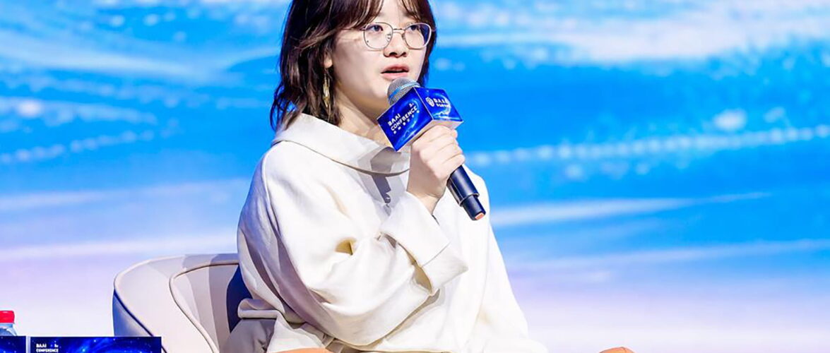 Luo Fuli, head of Xiaomi’s MiMo team, speaking during the Beijing Academy of Artificial Intelligence (BAAI) Conference on June 12. Photo source: 2026 BAAI Conference.