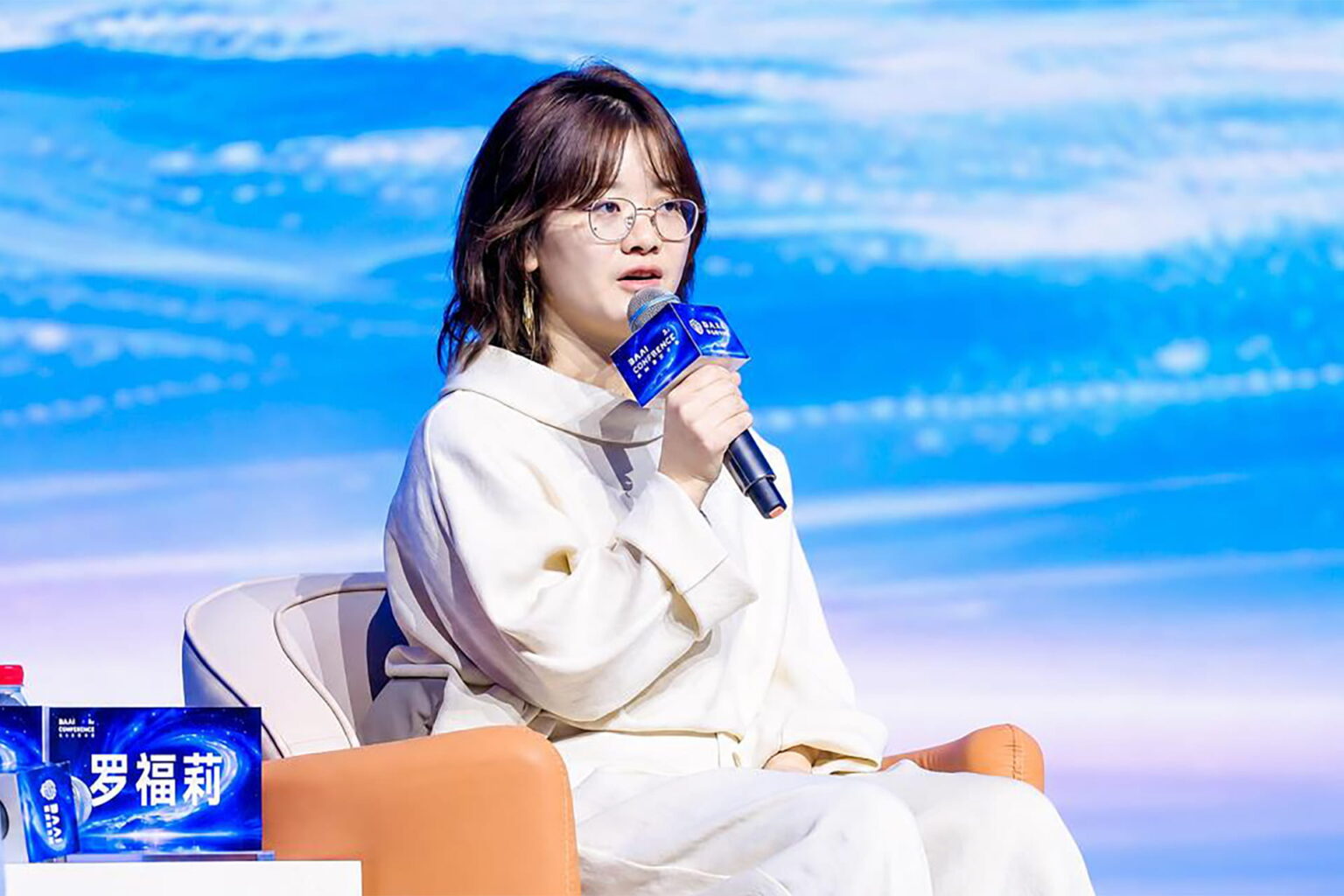 Luo Fuli, head of Xiaomi’s MiMo team, speaking during the Beijing Academy of Artificial Intelligence (BAAI) Conference on June 12. Photo source: 2026 BAAI Conference.