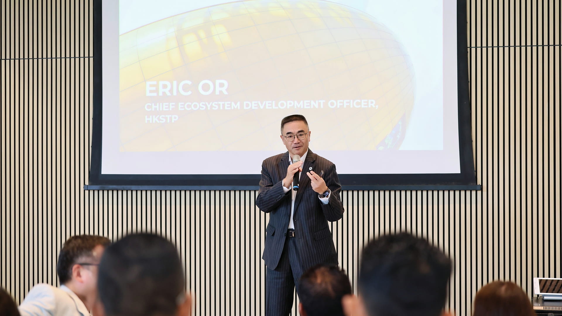 Photo of Eric Or, chief ecosystem development officer of HKSTP, speaking to the media and guests during a tour held ahead of the GBA-ASEAN Summit 2026.