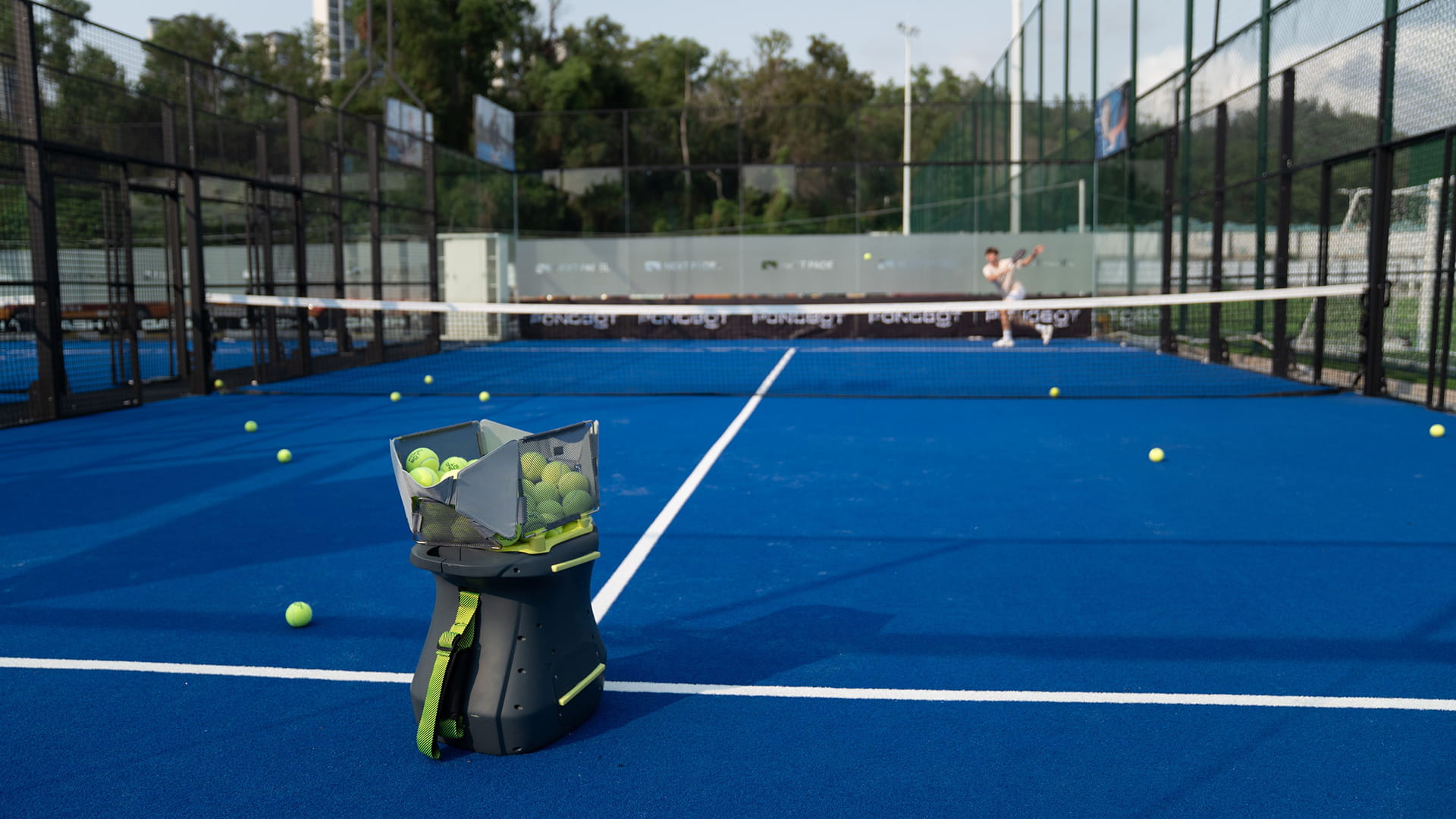 Photo of Pongbot’s Aura robot, deployed during tennis practice.