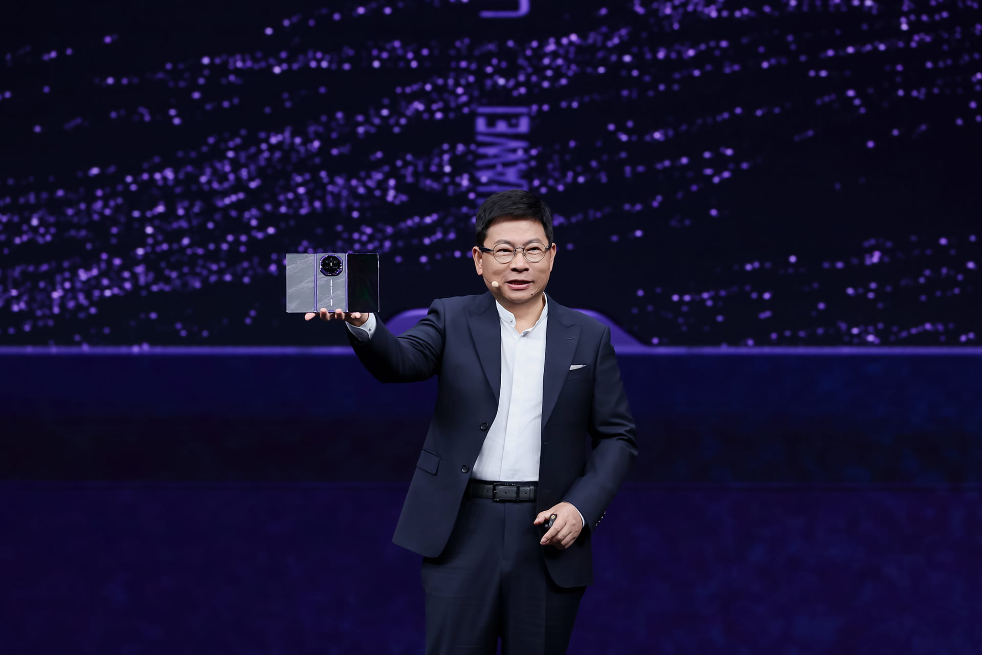 Photo of Huawei executive director Richard Yu, also known as Yu Chengdong, holding up the Mate XT 2 onstage during the foldable smartphone’s launch on September 7, 2026.