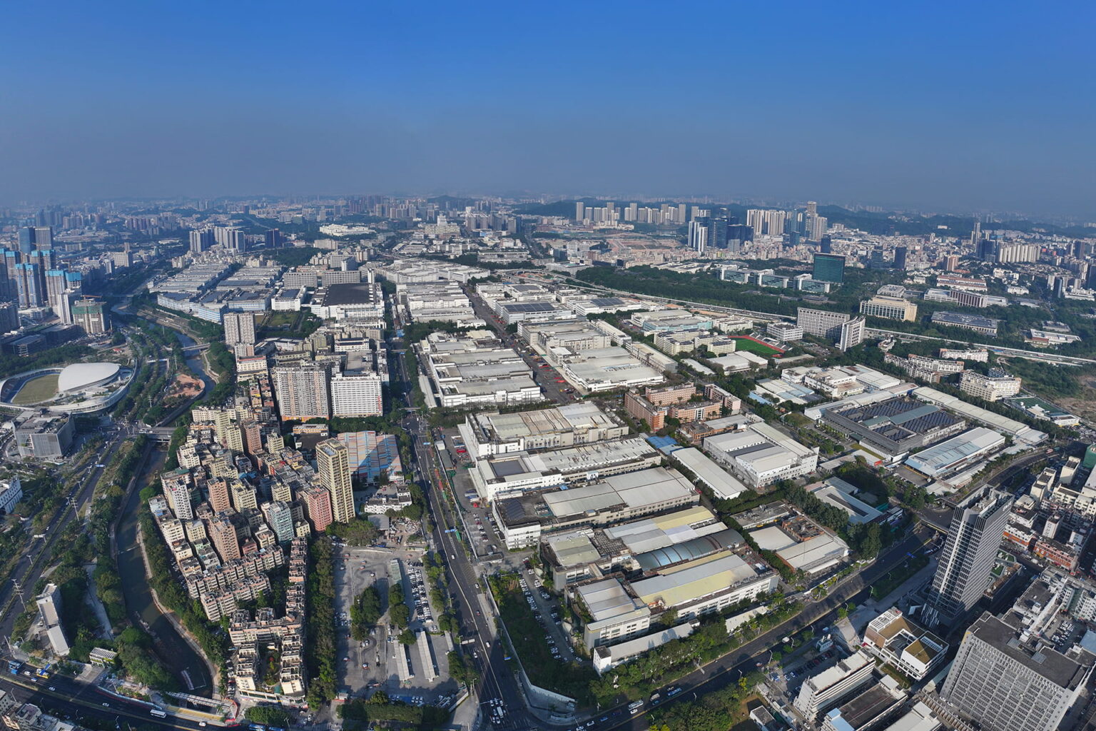 Longhua Science and Technology Park in Shenzhen is one of Foxconn’s major manufacturing sites. Its sprawling industrial complex contains factory buildings arranged in a dense grid. Photo source: Dreamstime (<a href="https://www.dreamstime.com/5822847_info" style="border-bottom: 1px solid #1266f1; text-decoration: none;" onmouseover="this.style.color='#1266f1'" onmouseout="this.style.color=''">5822847</a>, ID: 400939203).