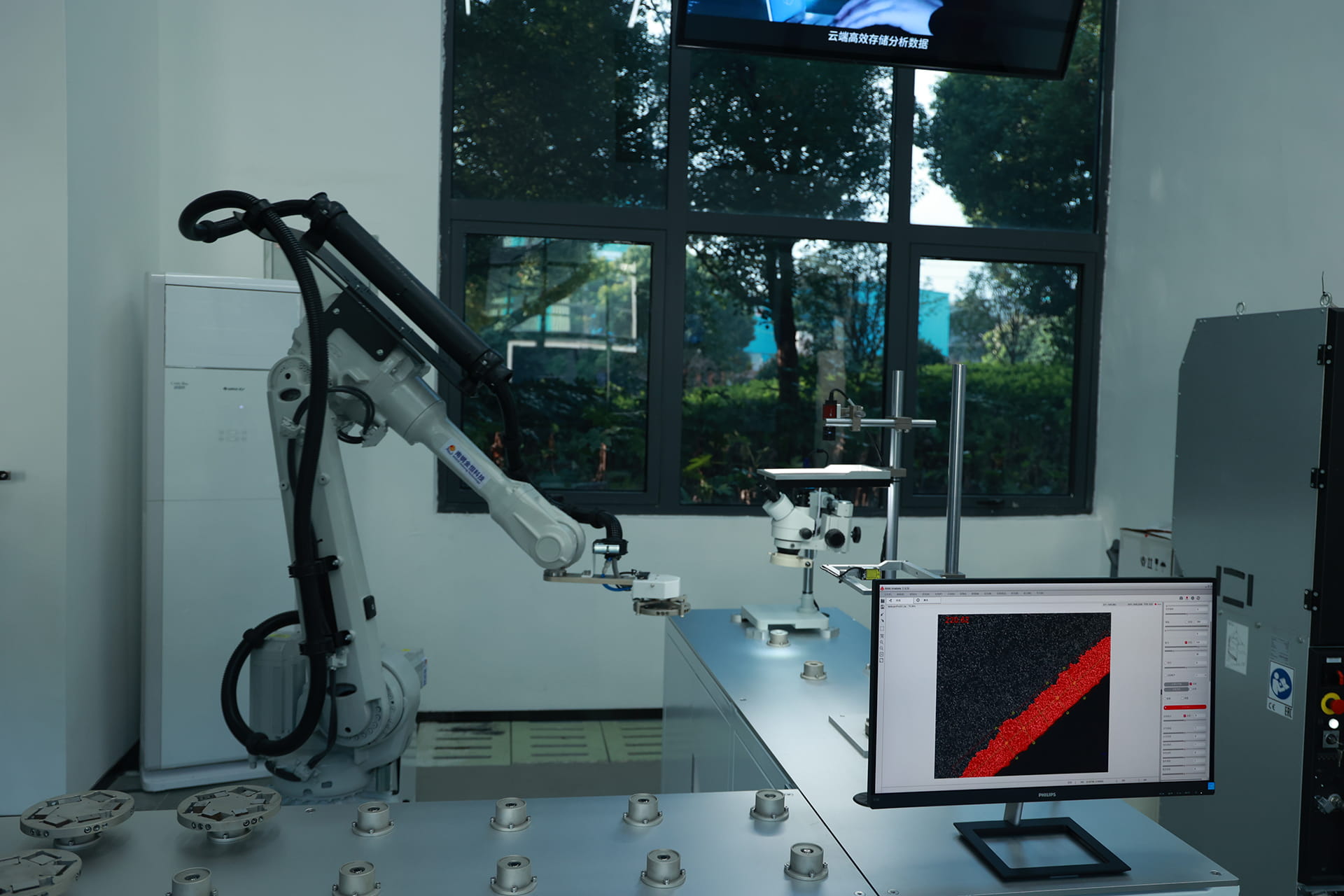 Photo shows NISCO’s metallographic inspection laboratory, where robotic arms are deployed.